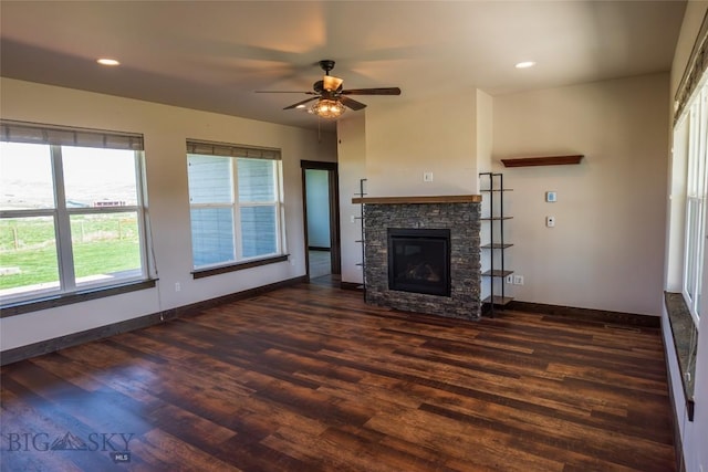 unfurnished living room with a ceiling fan, dark wood finished floors, baseboards, a fireplace, and recessed lighting