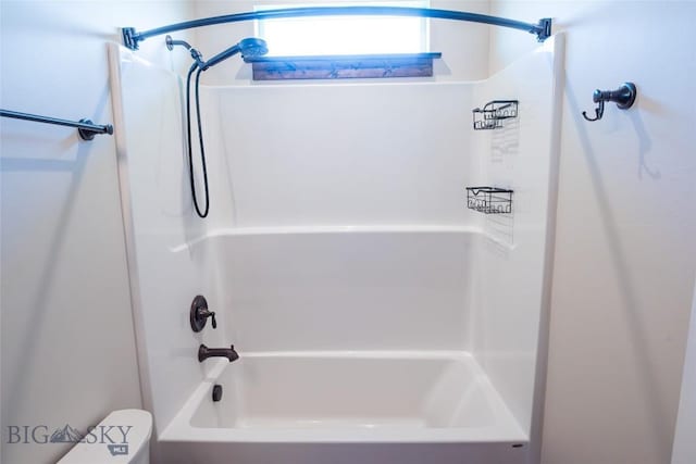 bathroom with toilet and washtub / shower combination