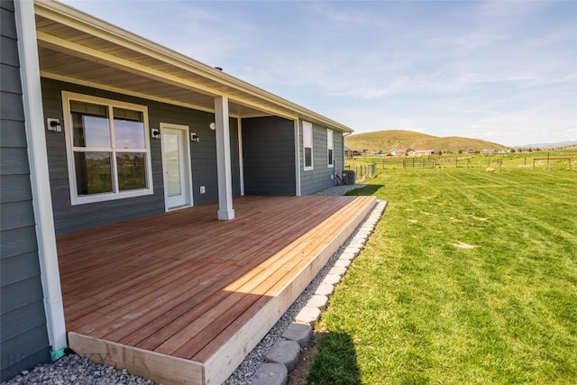 wooden deck with a mountain view and a view of rural / pastoral area