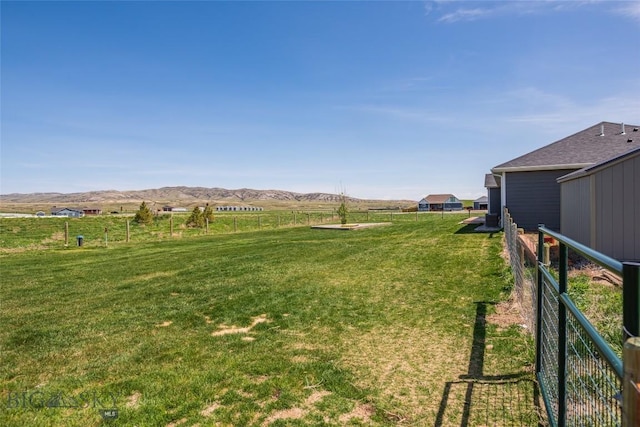 view of yard with a view of rural / pastoral area and a mountain view