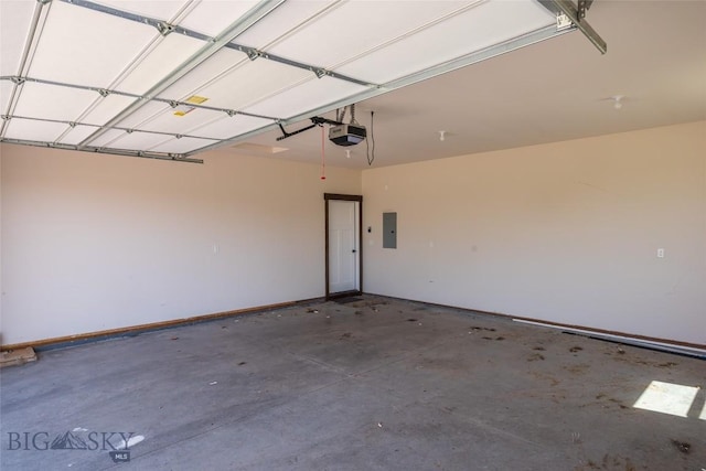 garage with a garage door opener, electric panel, and baseboards