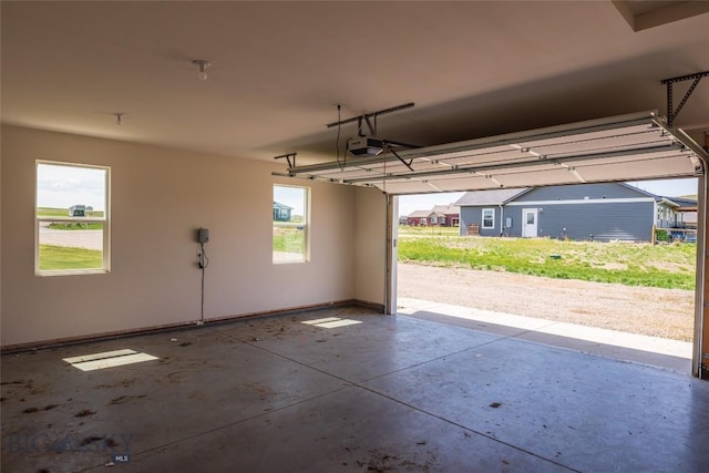 garage with a garage door opener and baseboards