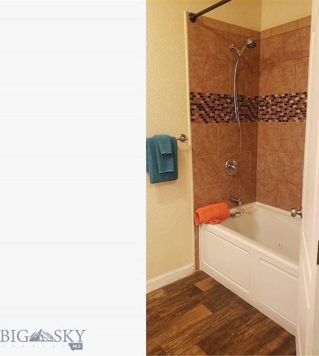 225 N Geyser St, West Yellowstone, MT 59758 - full bathroom featuring wood finished floors, shower / bath combination, and baseboards