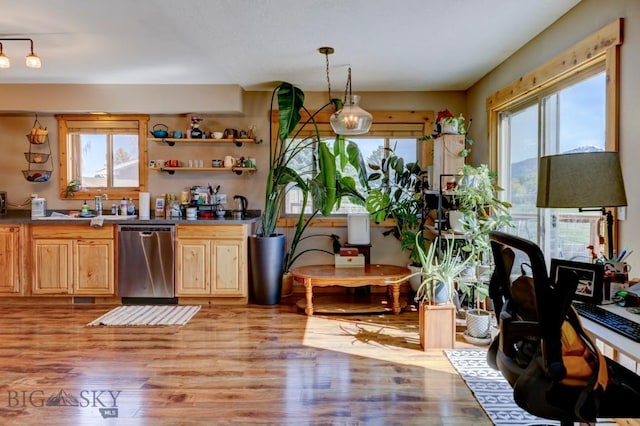 1816 S Rouse Unit 1 & 2, Bozeman, MT 59715 - kitchen with stainless steel dishwasher, light wood finished floors, light brown cabinetry, and decorative light fixtures