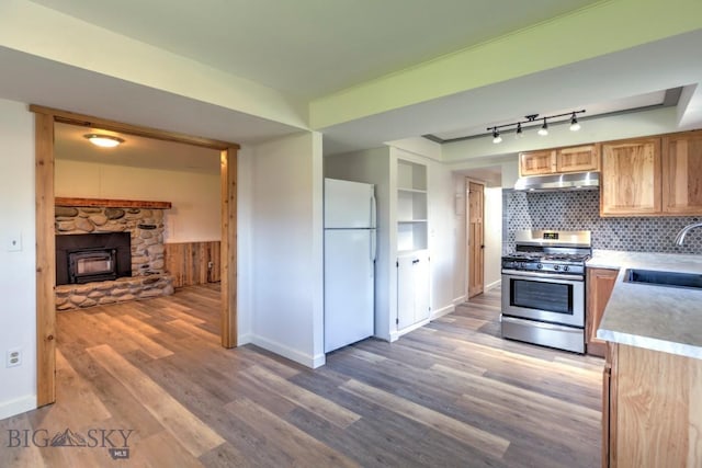 1816 S Rouse Unit 1 & 2, Bozeman, MT 59715 - kitchen featuring freestanding refrigerator, stainless steel gas range, a sink, under cabinet range hood, and light countertops