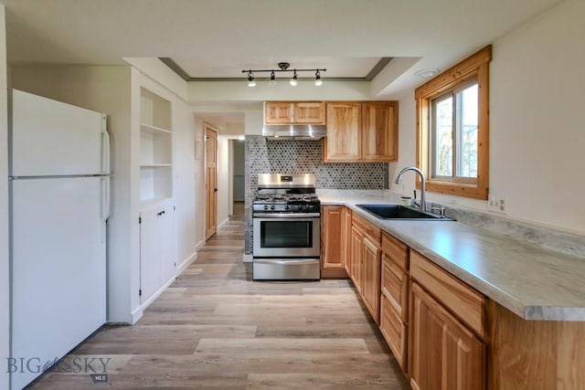 1816 S Rouse Unit 1 & 2, Bozeman, MT 59715 - kitchen with freestanding refrigerator, stainless steel gas range, a sink, under cabinet range hood, and light wood-type flooring