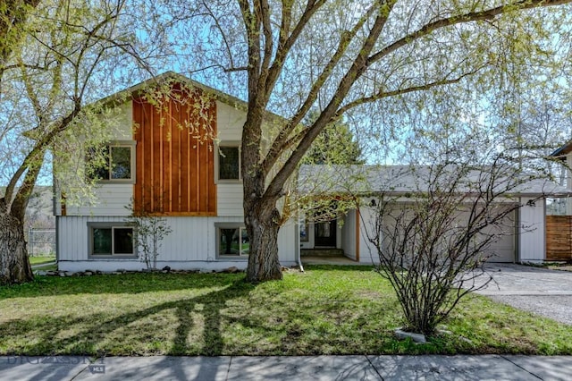 1816 S Rouse, Bozeman, MT 59715 - view of front of property featuring concrete driveway, an attached garage, and a front yard