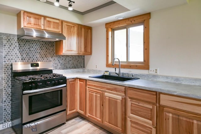 1816 S Rouse, Bozeman, MT 59715 - kitchen with stainless steel gas range, under cabinet range hood, a sink, tasteful backsplash, and light countertops
