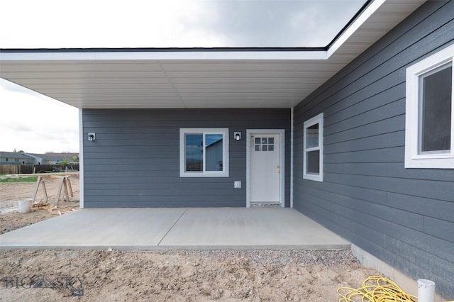 view of exterior entry featuring a patio