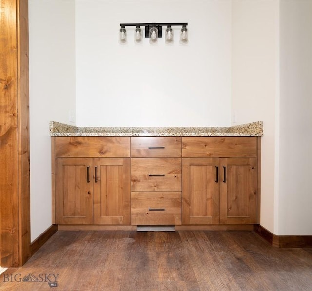 bathroom with wood finished floors and baseboards