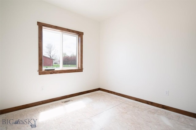 spare room featuring baseboards
