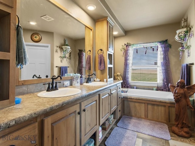 full bathroom with double vanity and a garden tub