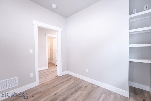 440 Meriwether Ave, Bozeman, MT 59718 - spare room with wood finished floors, baseboards, a smoke detector, and built in features