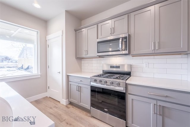 440 Meriwether Ave, Bozeman, MT 59718 - kitchen with appliances with stainless steel finishes, gray cabinetry, light wood finished floors, and recessed lighting