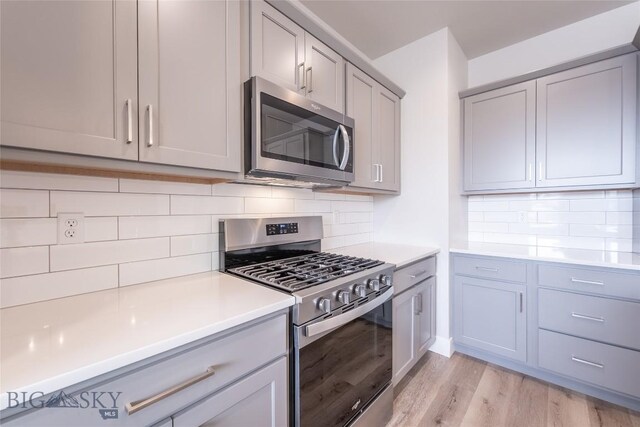 440 Meriwether Ave, Bozeman, MT 59718 - kitchen featuring appliances with stainless steel finishes, gray cabinets, light countertops, and light wood-style flooring