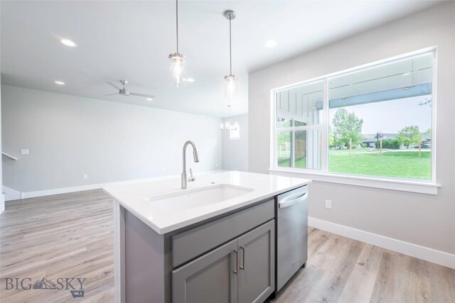 440 Meriwether Ave, Bozeman, MT 59718 - kitchen with gray cabinetry, a sink, stainless steel dishwasher, light wood finished floors, and hanging light fixtures