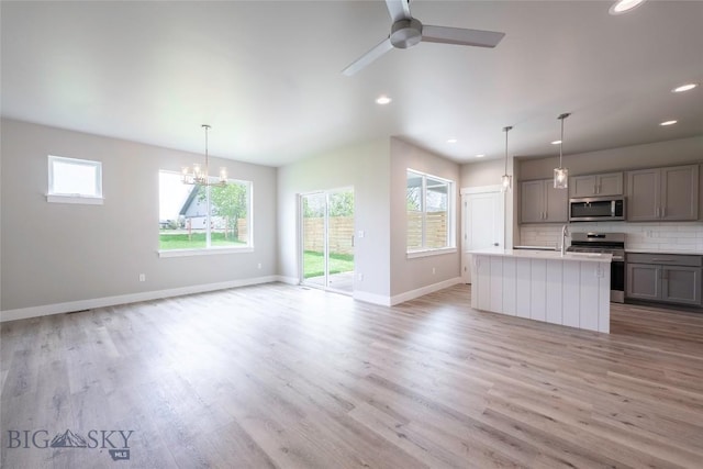 440 Meriwether Ave, Bozeman, MT 59718 - kitchen featuring appliances with stainless steel finishes, gray cabinetry, plenty of natural light, light wood-type flooring, and recessed lighting