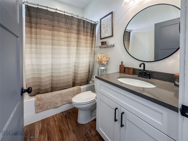full bath featuring toilet, shower / bath combo, vanity, and wood finished floors