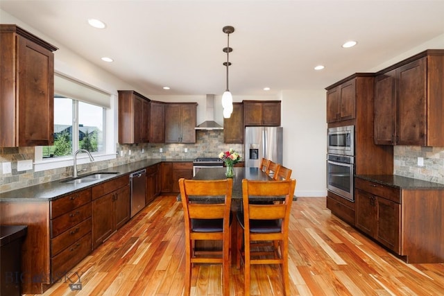 342 Parklands Trl, Bozeman, MT 59718 - kitchen featuring stainless steel appliances, a sink, wall chimney exhaust hood, light wood-type flooring, and recessed lighting