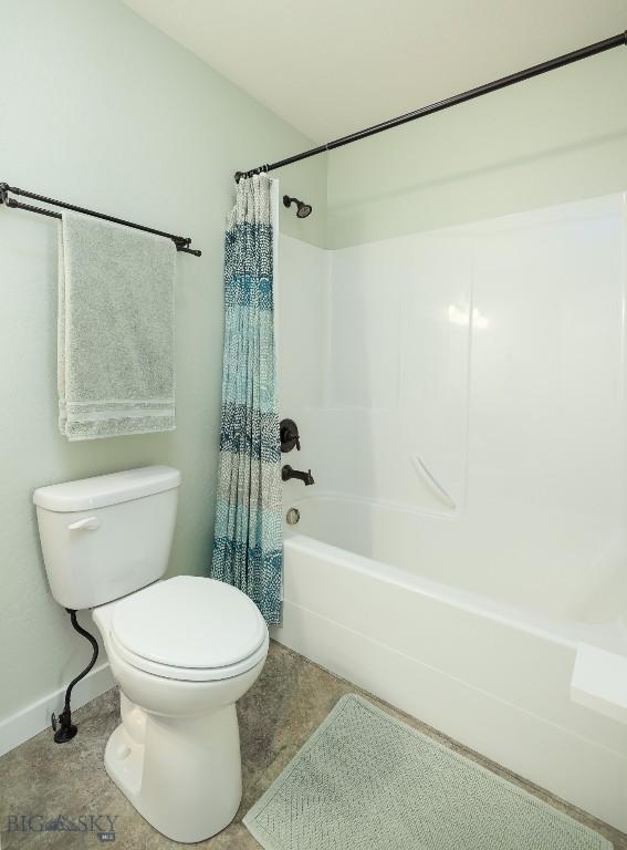 342 Parklands Trl, Bozeman, MT 59718 - bathroom featuring toilet, shower / tub combo, and baseboards