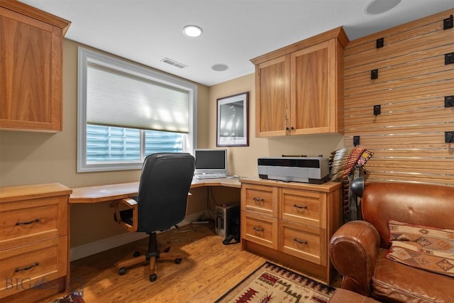 office space featuring light wood-type flooring and built in study area