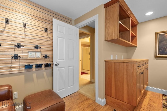 mudroom featuring light wood-style floors and baseboards