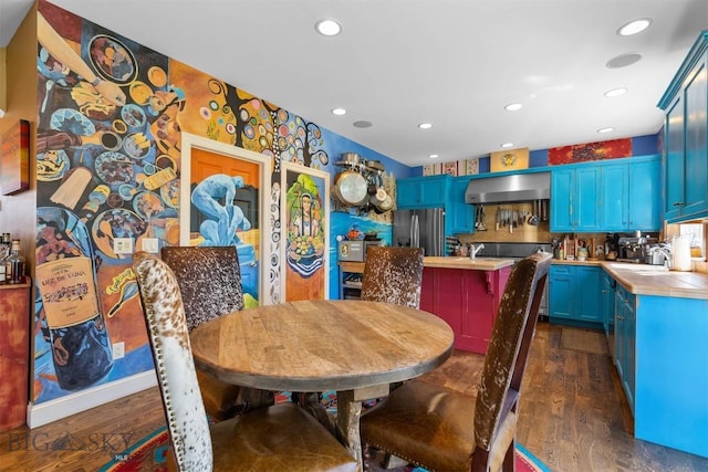 dining space featuring dark wood-type flooring and recessed lighting