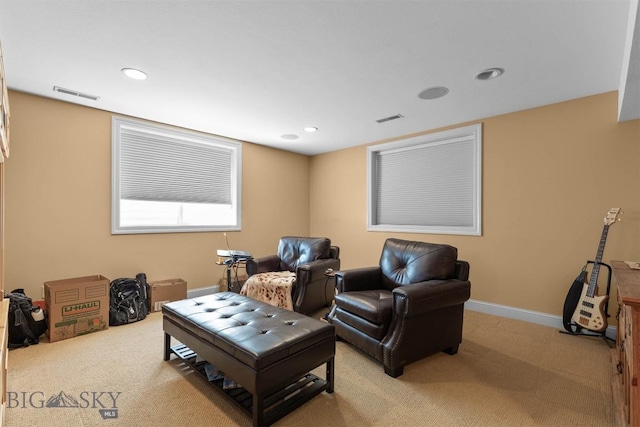 carpeted living room with recessed lighting and baseboards