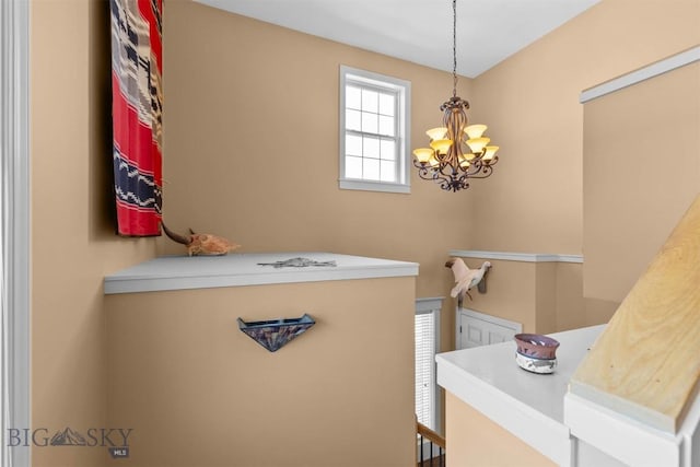 laundry room featuring a chandelier