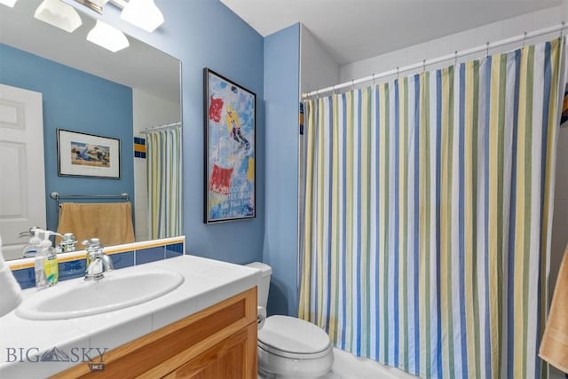 full bathroom featuring toilet, vanity, and curtained shower