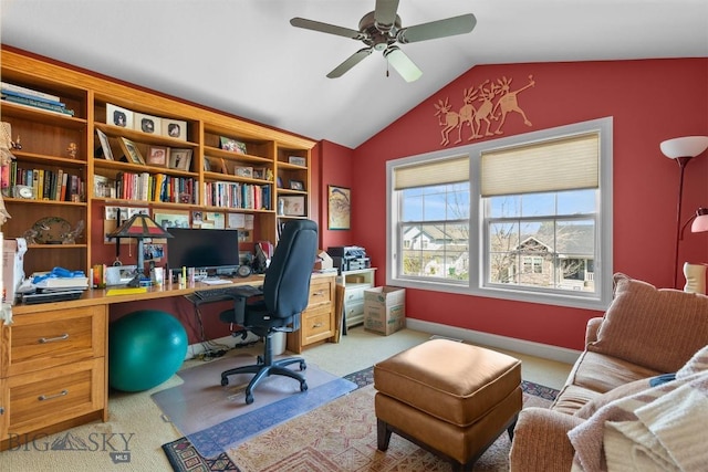carpeted office with vaulted ceiling and a ceiling fan
