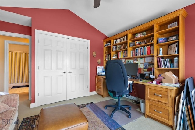 carpeted office space featuring lofted ceiling and ceiling fan