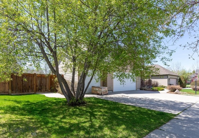 view of property hidden behind natural elements with an attached garage