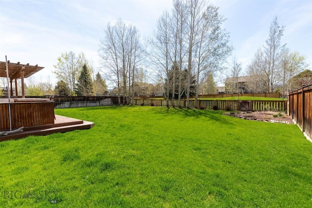 view of yard featuring a wooden deck and a pergola