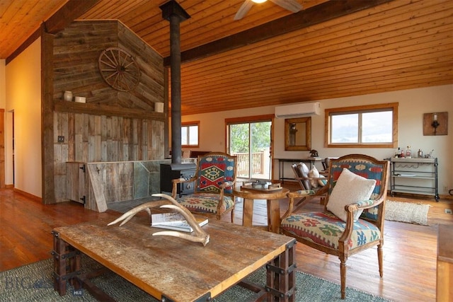 28 Loch Leven Rd, Livingston, MT 59047 - sitting room with a wood stove, wood finished floors, a wall unit AC, wood ceiling, and a ceiling fan