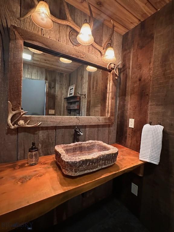 28 Loch Leven Rd, Livingston, MT 59047 - bathroom featuring wood walls, a sink, and wooden ceiling