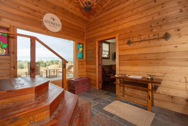 28 Loch Leven Rd, Livingston, MT 59047 - entryway featuring stone tile flooring, wood walls, and high vaulted ceiling