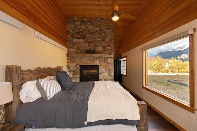 28 Loch Leven Rd, Livingston, MT 59047 - bedroom with wooden ceiling, vaulted ceiling, wood finished floors, a stone fireplace, and baseboards