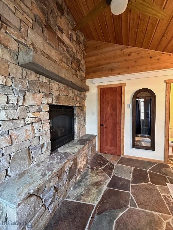 28 Loch Leven Rd, Livingston, MT 59047 - unfurnished living room featuring wooden ceiling, dark stone finish flooring, a fireplace, baseboards, and high vaulted ceiling