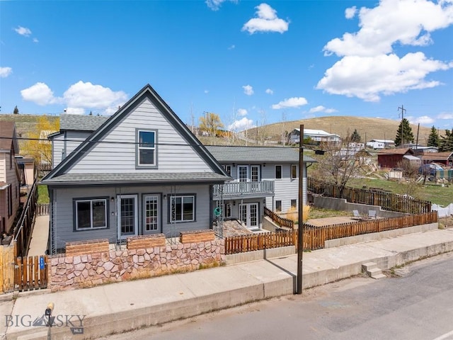 517 W Daly, Walkerville, MT 59701 - view of front facade with french doors, a fenced backyard, and roof with shingles