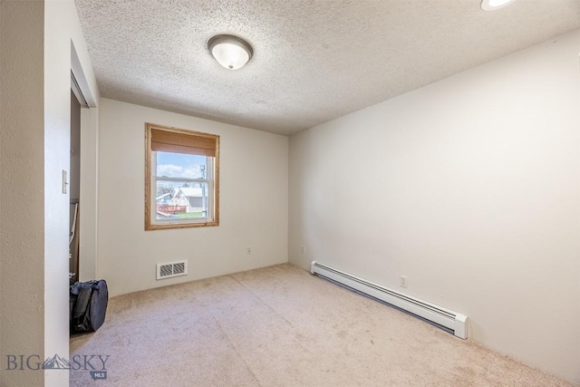 517 W Daly, Walkerville, MT 59701 - spare room featuring a baseboard radiator, carpet floors, and a textured ceiling
