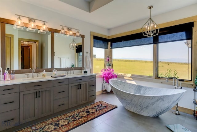 419 Upper Autumn Ridge Rd, Bozeman, MT 59715 - bathroom with healthy amount of natural light, double vanity, a chandelier, and a freestanding tub