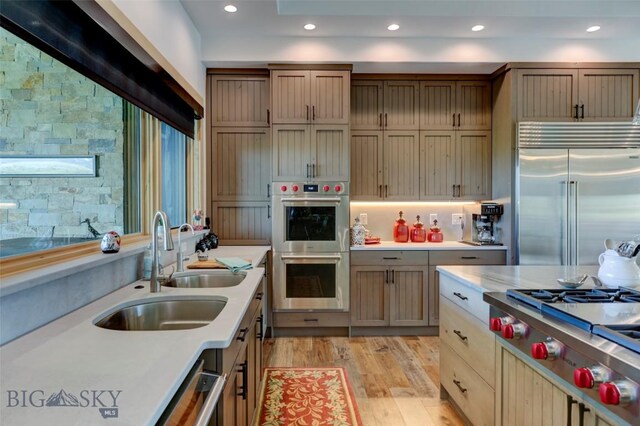 419 Upper Autumn Ridge Rd, Bozeman, MT 59715 - kitchen featuring appliances with stainless steel finishes, light countertops, light wood-style floors, a sink, and recessed lighting