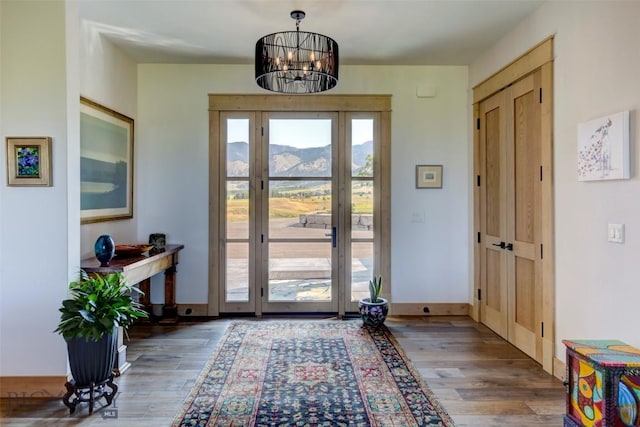 419 Upper Autumn Ridge Rd, Bozeman, MT 59715 - entryway featuring wood finished floors, a chandelier, a mountain view, and baseboards