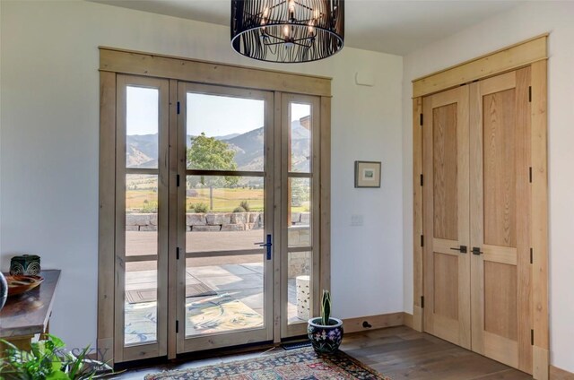 419 Upper Autumn Ridge Rd, Bozeman, MT 59715 - foyer with wood finished floors, a chandelier, french doors, and baseboards