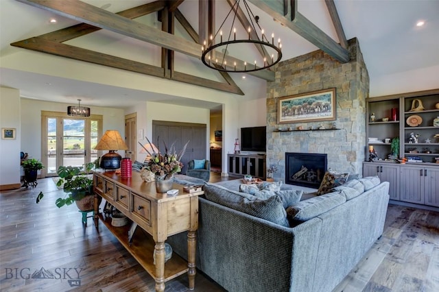 419 Upper Autumn Ridge Rd, Bozeman, MT 59715 - living area with high vaulted ceiling, beam ceiling, a chandelier, wood finished floors, and a stone fireplace