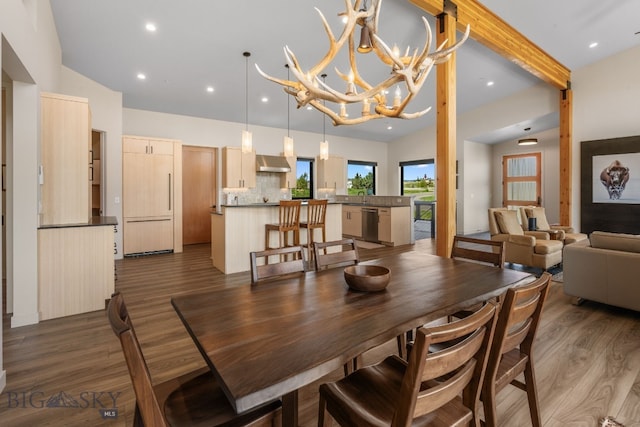 20 Prairie Falcon Ln, Belgrade, MT 59714 - dining area featuring dark wood finished floors, a chandelier, recessed lighting, and vaulted ceiling