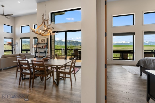 20 Prairie Falcon Ln, Belgrade, MT 59714 - dining space featuring a high ceiling, a chandelier, wood finished floors, recessed lighting, and a mountain view
