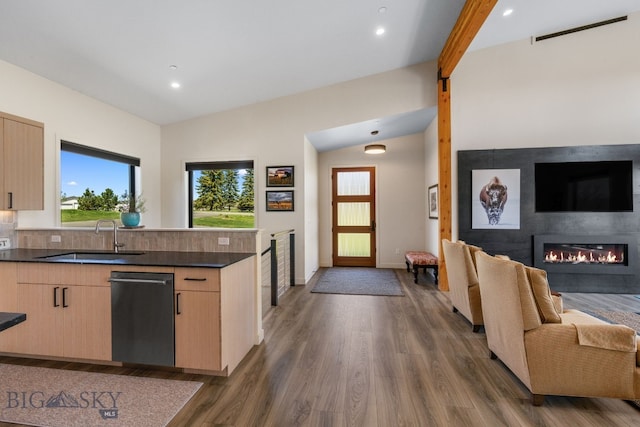 20 Prairie Falcon Ln, Belgrade, MT 59714 - kitchen with open floor plan, a sink, light brown cabinetry, a glass covered fireplace, and dishwasher