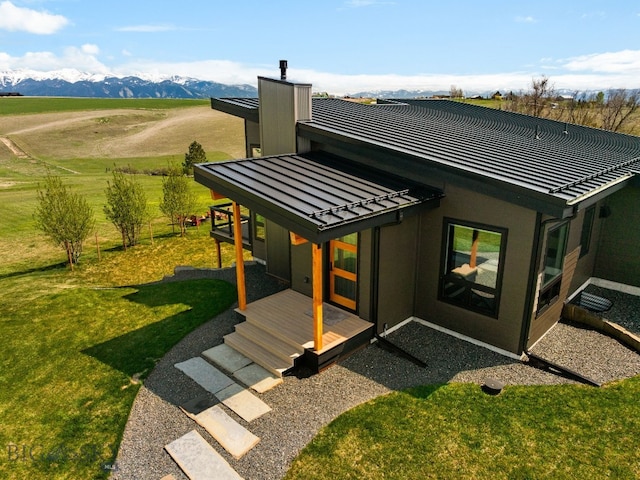 20 Prairie Falcon Ln, Belgrade, MT 59714 - back of house with a yard, a mountain view, a chimney, a tiled roof, and a rural view